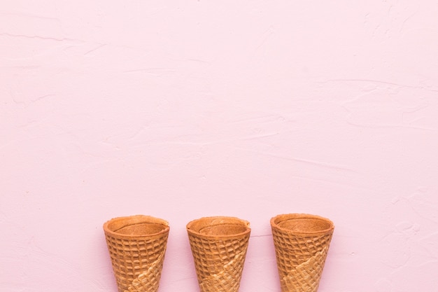 Waffle cones on pink background