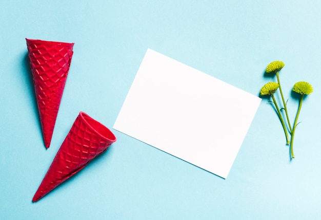 Waffle cones and sheet of paper on light background