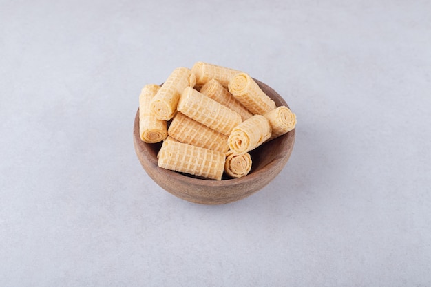 Waffle rolls in a bowl, on the marble.