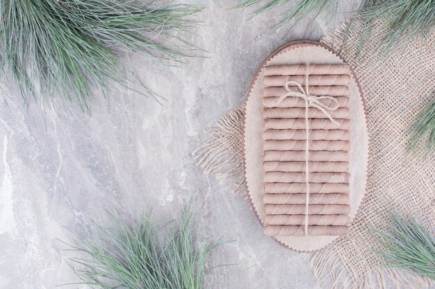 Waffle sticks on wooden platter on rustic.