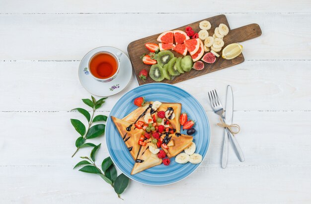 Waffles and fruits in blue plate with fruits