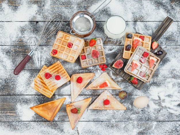 Waffles on wooden board with berries