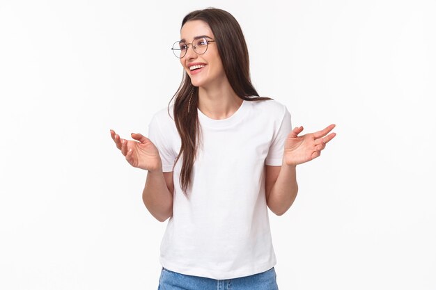 Waist-up portrait of carefree smiling attractive girl in glasses