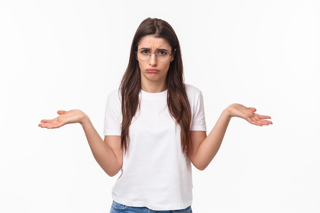 Free photo waist-up portrait of indecisive distressed, gloomy young woman in glasses