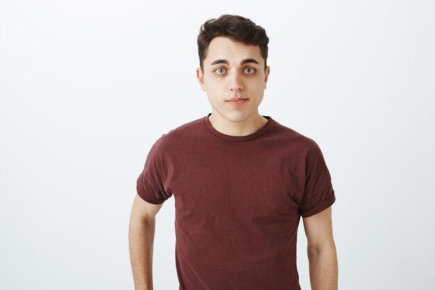 Waist-up shot of handsome ordinary caucasian man in red t-shirt