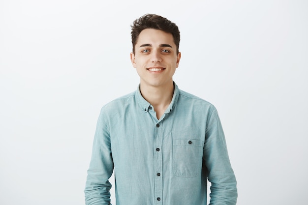 Waist-up shot of healthy happy caucasian guy with short haircut