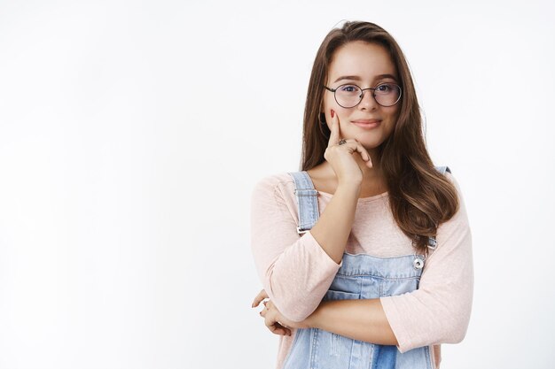 Waist-up shot of skillful and creative attractive caucasian woman in glasses having interesting idea