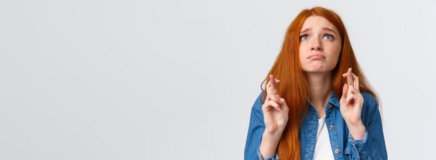 Free photo waistup portrait hopeful and nervous cute gloomy girl with red hair blue eyes begging god help looki