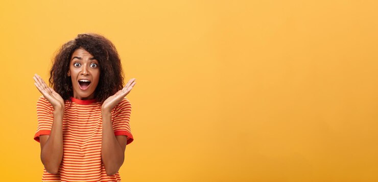 Free Photo waistup shot of amazed joyful sociable darkskinned female with afro hairstyle in striped tshirt