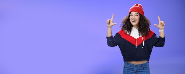 Waistup shot of cheerful energized young woman calling friend inviting hang out as weather awesome p