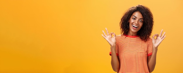 Waistup shot of chill outgoing calm girlfriend with confident look in trendy striped tshirt showing 