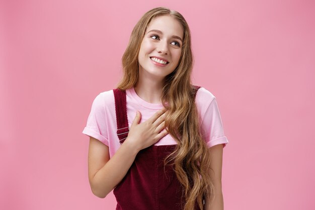 Waistup shot of delighted charming friendlylooking tender female with cute white smile in corduroy o...