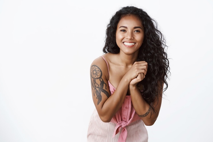 Free Photo waistup shot elegant goodlooking african american curlyhaired female with tattoos no blemishes tilt head smiling grateful look touched and delighted feeling thankful stand white background
