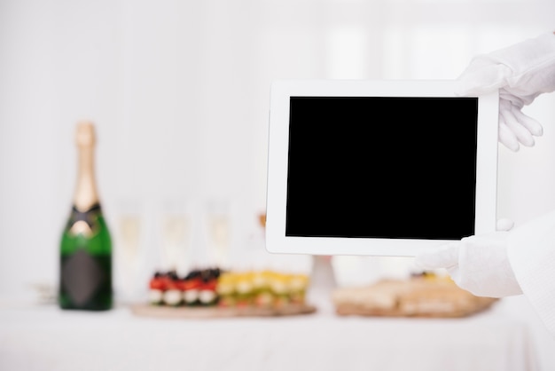 Waiter holding tablet with mockup