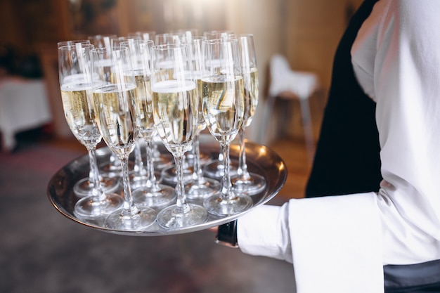 Waiter serving beverage on a tray in a restaurant