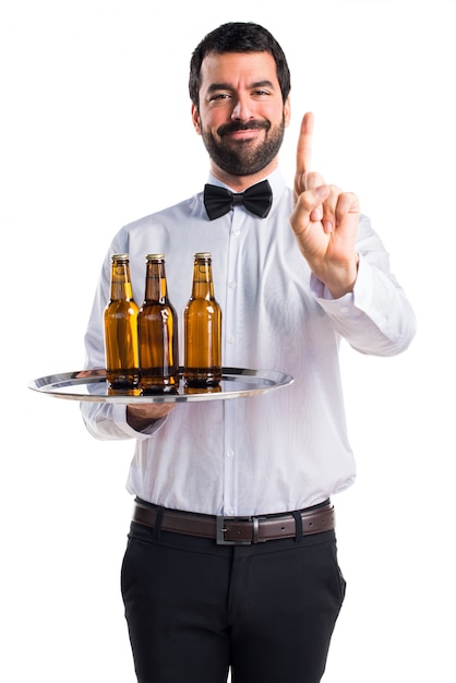 Waiter with beer bottles on the tray counting one