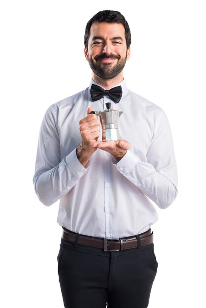 Waiter with beer bottles on the tray holding a coffee pot