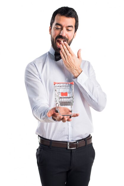 Waiter with beer bottles on the tray holding a supermarket cart