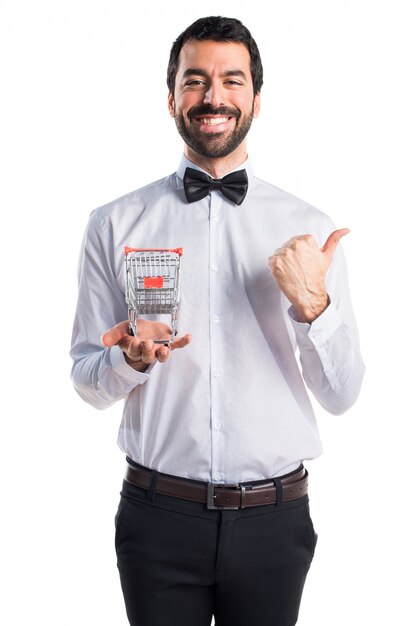 Waiter with beer bottles on the tray holding a supermarket cart