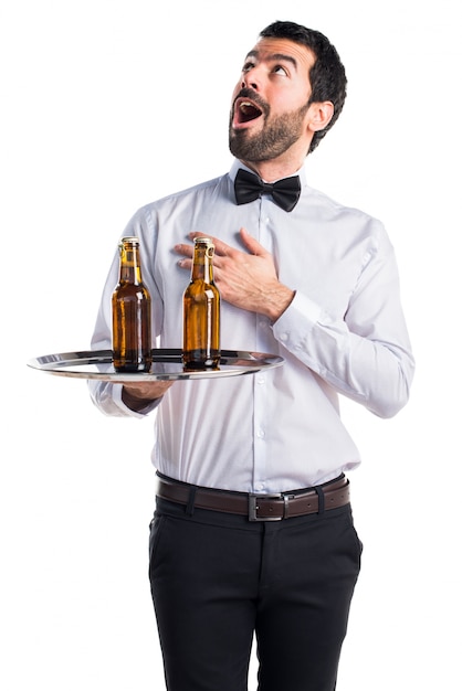 Waiter with beer bottles on the tray in love