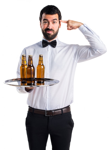 Free photo waiter with beer bottles on the tray making crazy gesture