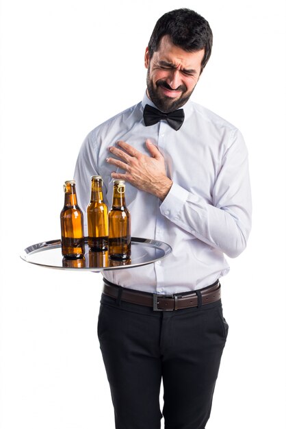 Waiter with beer bottles on the tray with heart pain