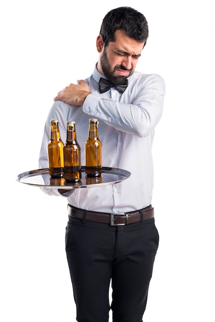 Waiter with beer bottles on the tray with shoulder pain
