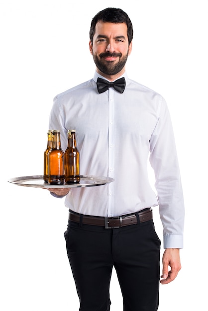 Free photo waiter with beer bottles on the tray