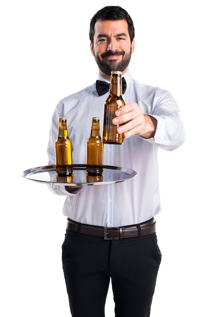 Waiter with beer bottles on the tray