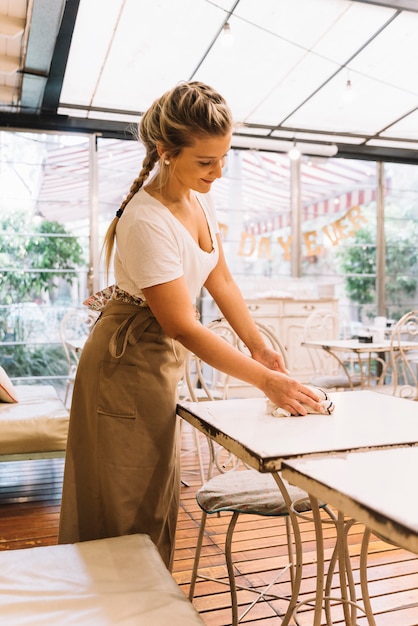 Waitress cleaning table
