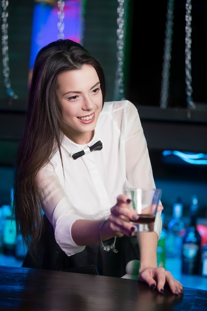 Waitress giving a drink to someone