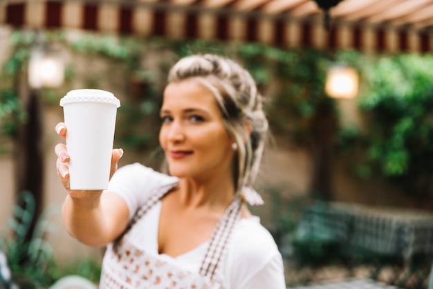 Waitress giving take away coffee