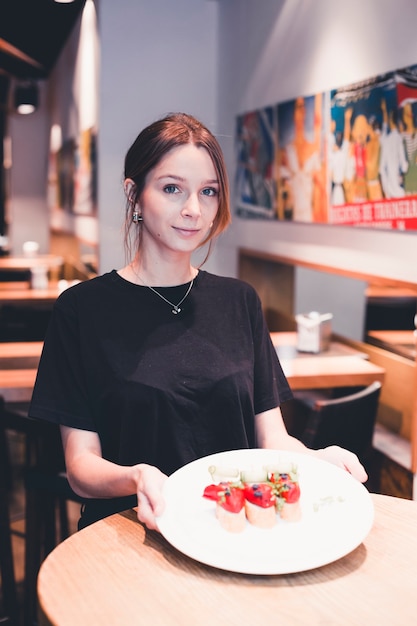 Waitress holding plate with tartines