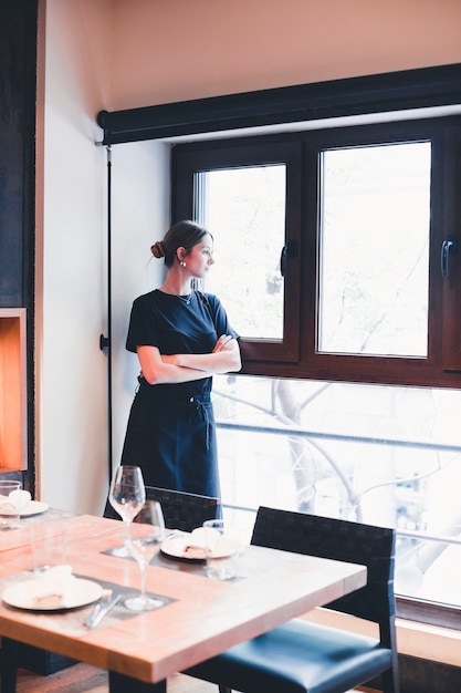 Waitress looking out window