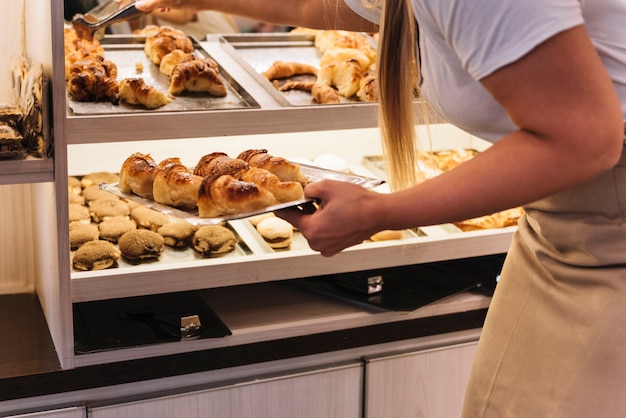 Waitress placing pastries