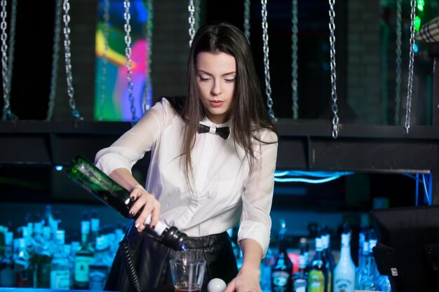 Waitress preparing a glass