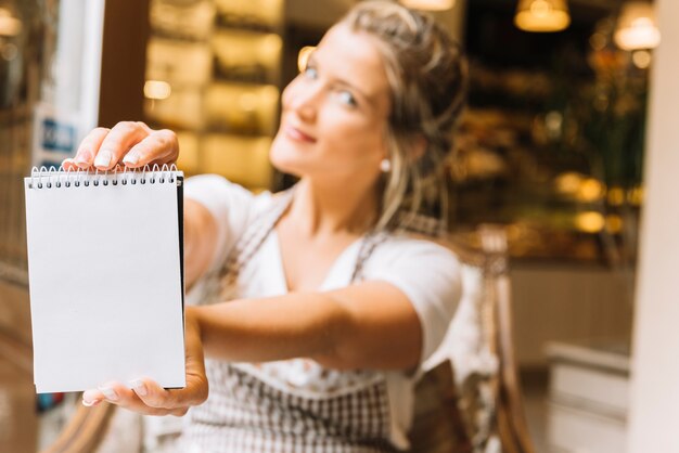 Waitress showing notebook