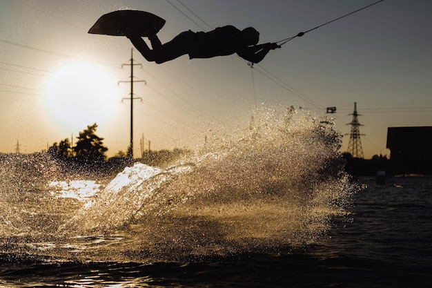 wakeboard. wakeboarding jumping at sunset