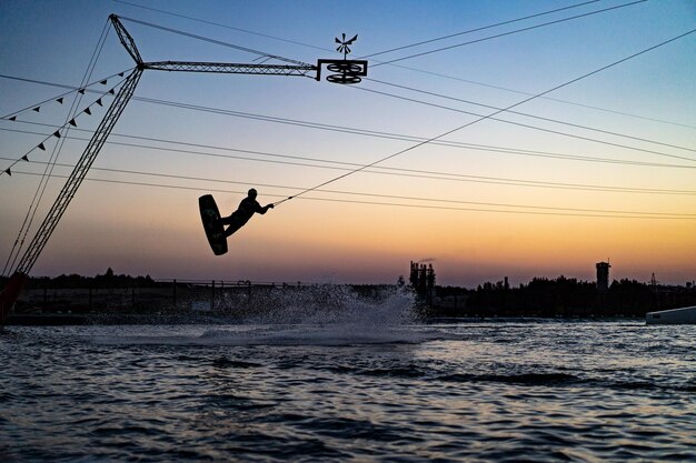 wakeboard. wakeboarding jumping at sunset