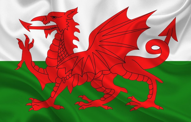 Wales country flag on wavy silk fabric background panorama - illustration