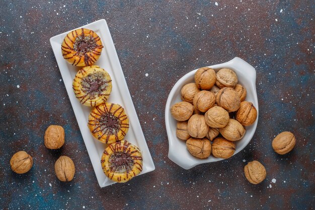 Walnut and chocolate cookies with walnuts around, top view