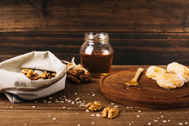 Walnut; donut; honey and cinnamon on wooden surface