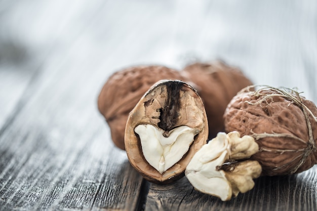 Free photo walnut in open form on a wooden wall, close-up .