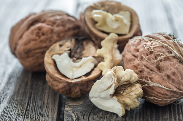 Walnut in open form on a wooden wall, close-up .