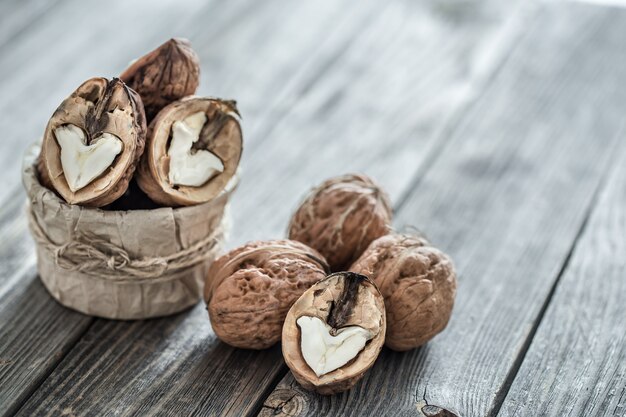 Walnut in open form on a wooden wall, close-up .