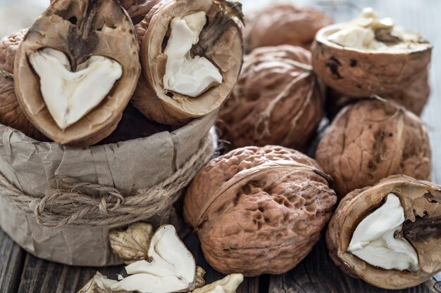 Walnut in open form on a wooden wall, close-up .