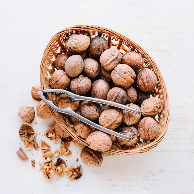 Walnuts in basket with nut mill