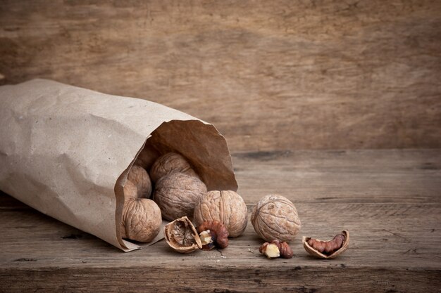 Walnuts In Craft Paper Bag On Yellow Background Delicious Nuts Healthy Nutrition Super Food Flat Lay Top View With Copy Space Premium Photo