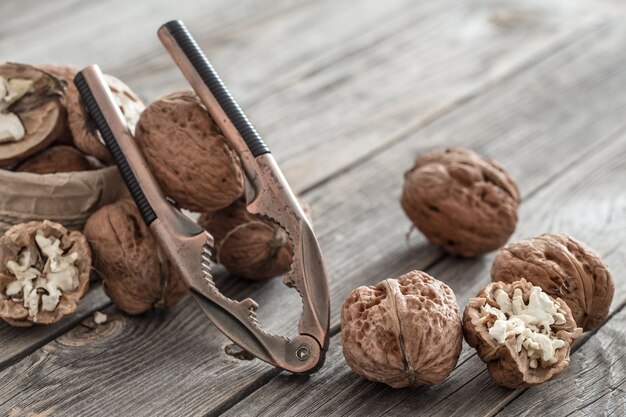 Walnuts and nutcracker on wooden table