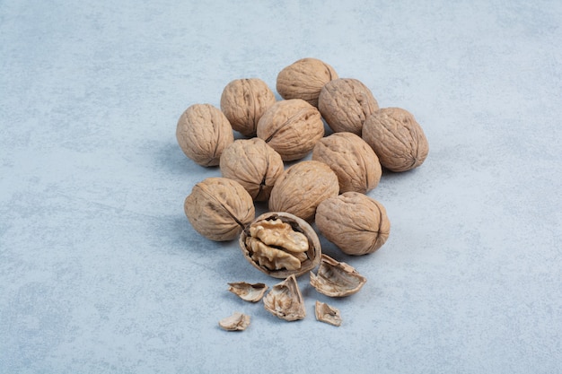 Walnuts and walnut kernels on blue background. High quality photo